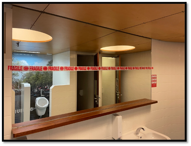 a tape that says "FRAGILE" is glued across the bathroom mirror 