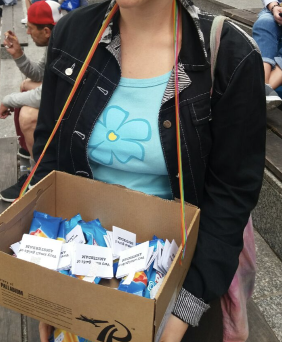a student carrying the box with ice cream and brochures 