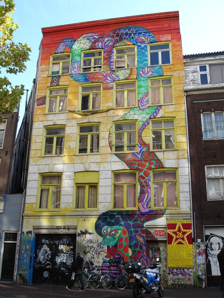 colorful snake graffiti that covers a whole building 