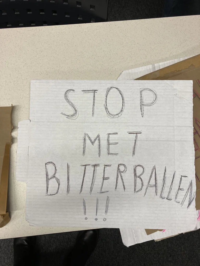 A sign that reads "Stop me Bitterballen". 